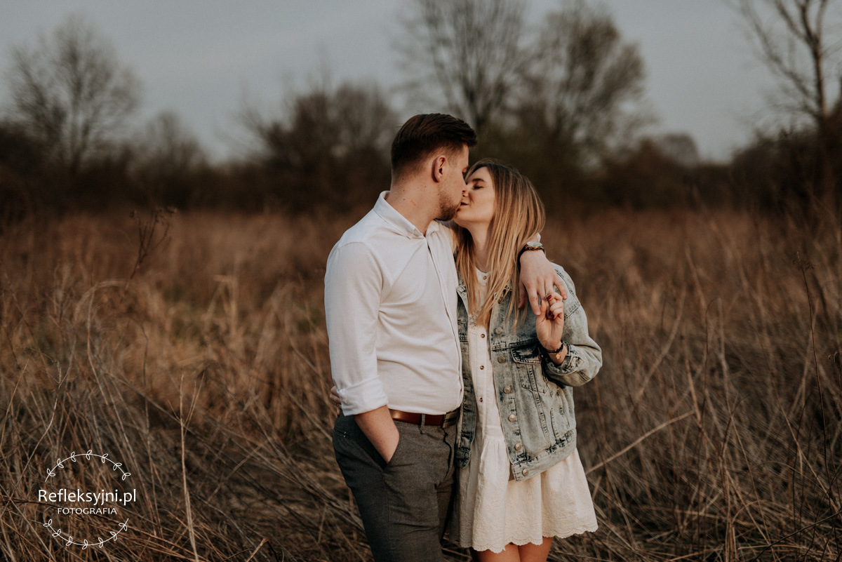 Mężczyzna i kobieta całujący się na polanie